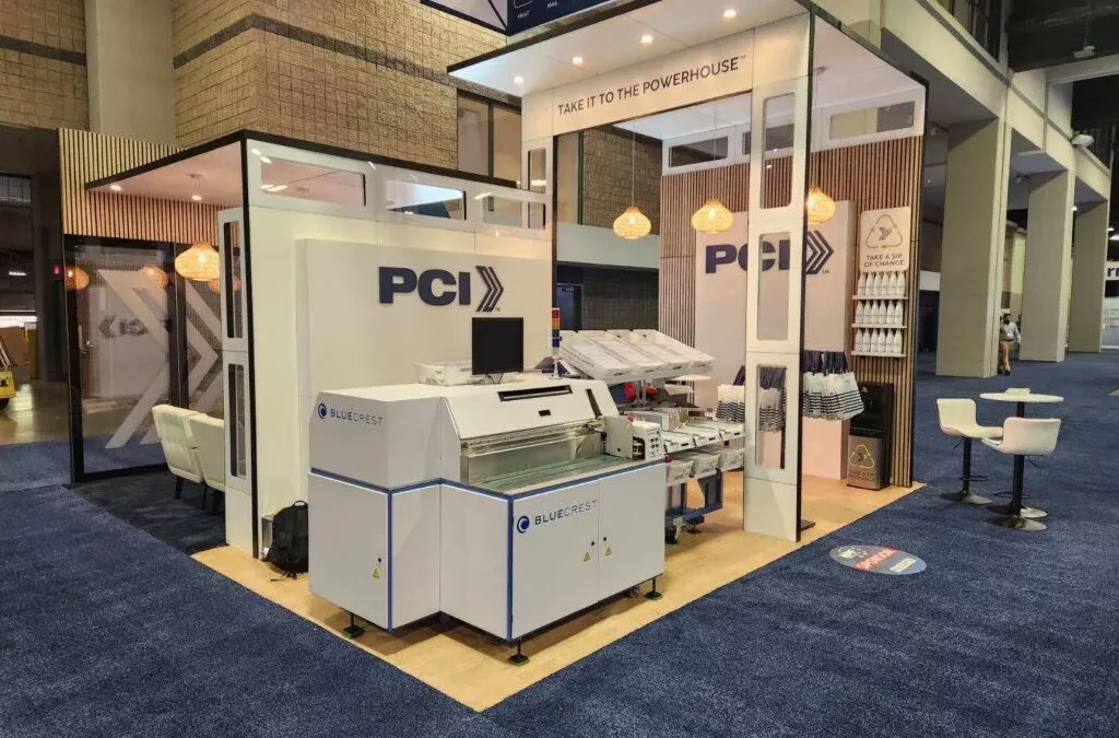 Postal Center International™ Unveils New Custom Tradeshow Booth Design and Buildout—Complete with Operational BlueCrest Elevate Sorter and Onsite Activations for High Touch, Immersive Experience